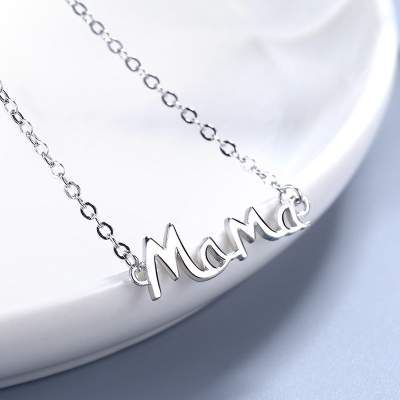 Special silver letters Mama necklace on a white ceramic plate