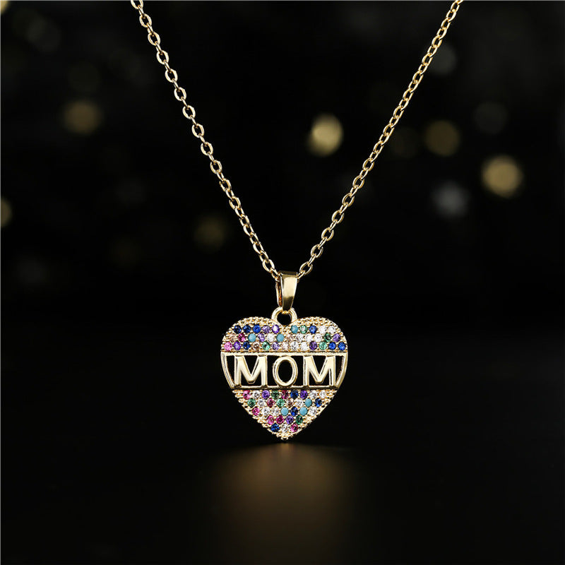 Gold heart pendant necklace with MOM letters on a white canvas