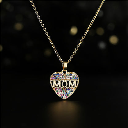 Gold heart pendant necklace with MOM letters on a white canvas