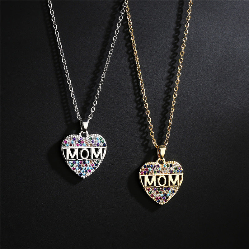 A pair of heart MOM pendants necklace on a black canvas