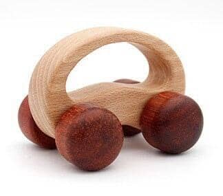 wooden car toy in two colors in a white canvas