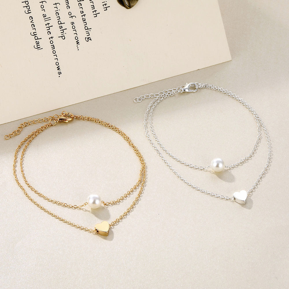 A silver and a Gold love beach summer anklet with a heart and a pearl