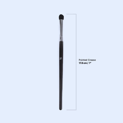 creased brush made of synthetic fibers with its dimensions in  a light blue canva