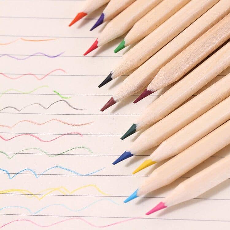Various colored pencils spread out on a blank piece of paper