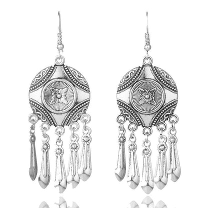Silver earrings with a tribal-inspired design and hanging tassels