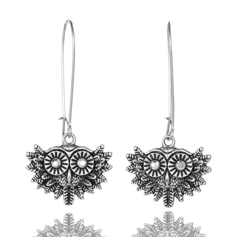 Vintage silver earrings featuring owl motifs and floral embellishments