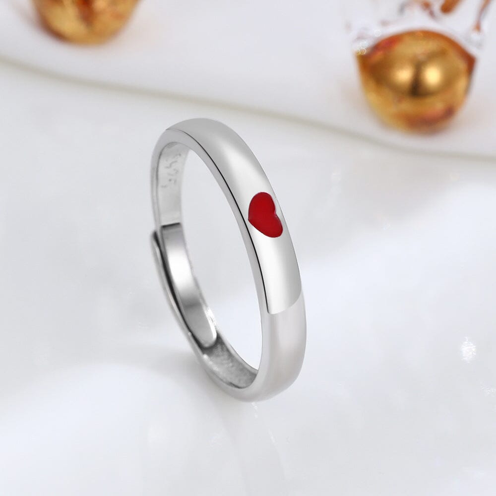 Single eco-friendly sterling silver ring with a prominent red heart detail