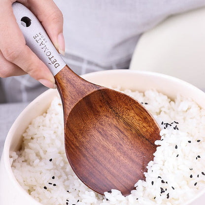  a teak wood spoon on a rice bowl