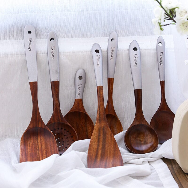 Assortment of teak wood kitchen utensils with natural finish