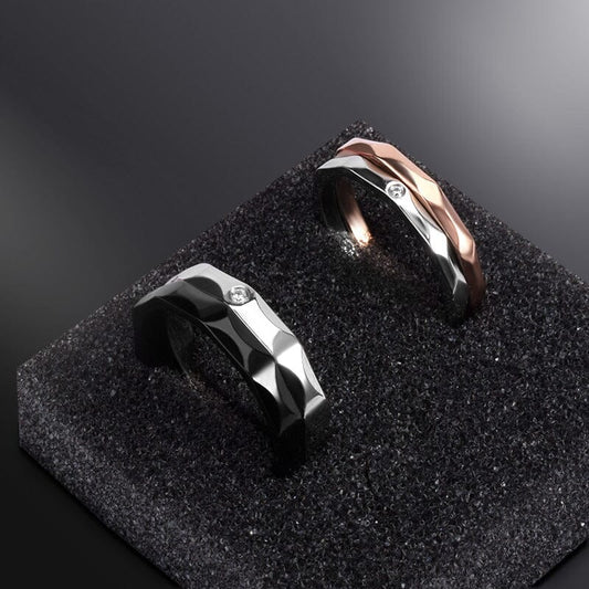 Eco-friendly titanium steel couple rings nestled inside a luxurious black presentation box