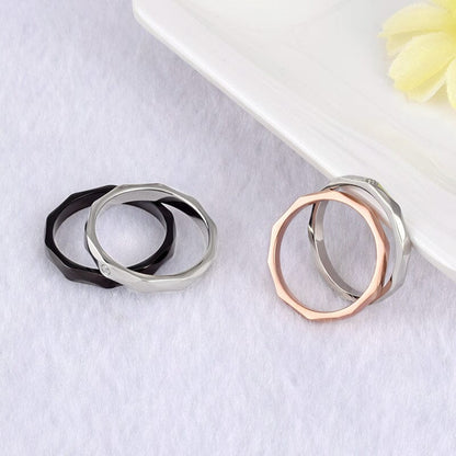 Eco-friendly titanium steel couple rings adorned with a decorative floral accent