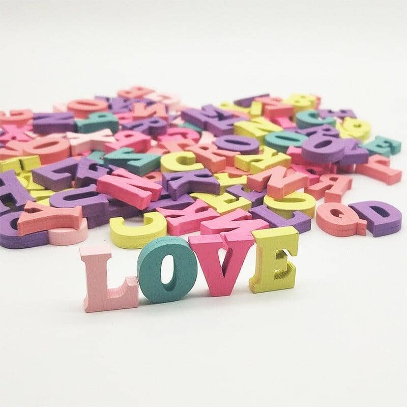The word "LOVE" spelled out with colorful wooden letter blocks