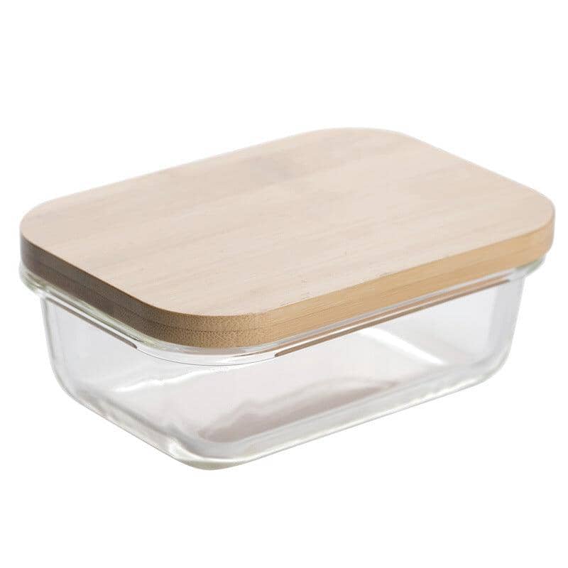 A glass container with a bamboo lid on a white background