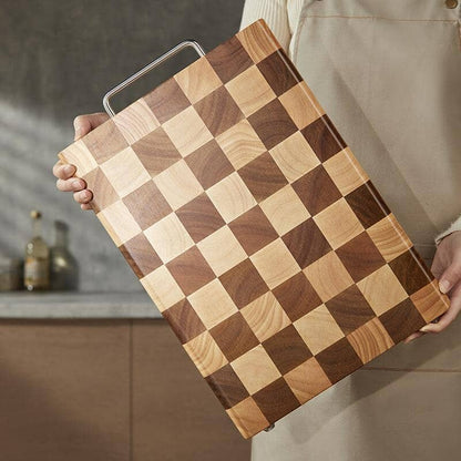 Someone holding a wood chopping board with square designs