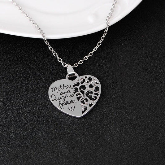 a silver pendant with a love message between mother and daughter