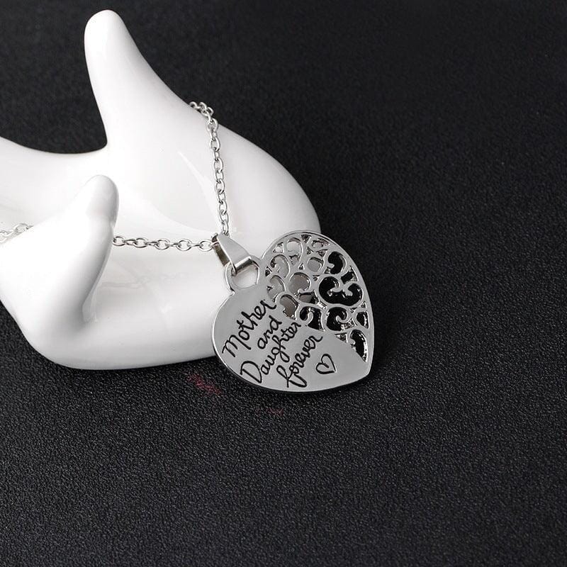 a heart pendant with a message of love between mother an daughter