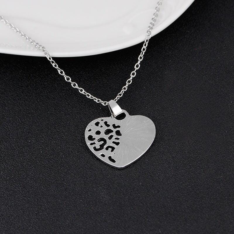 silver heart pendant necklace on a black background
