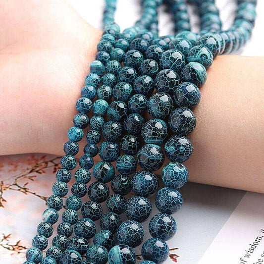 agate round beads of 6mm 8mm and 10mm over a woman arm