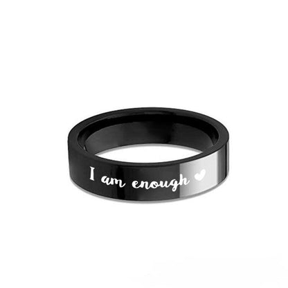 A black stainless steel ring with a message and a heart design