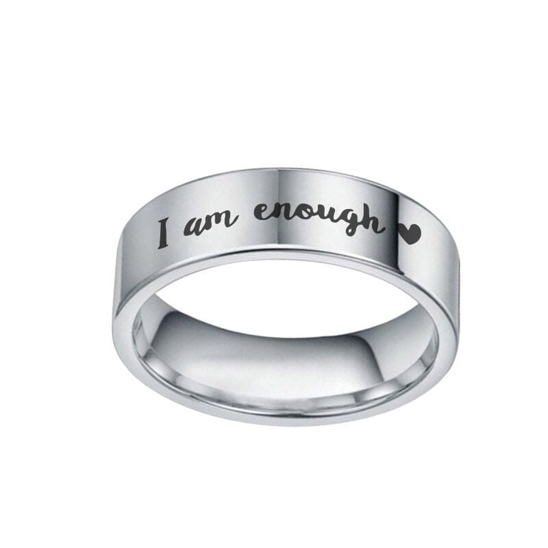 A stainless steal ring with a message on a white canvas