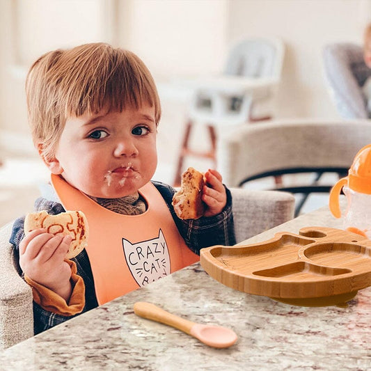 a child having a cookie using a dinner gift set