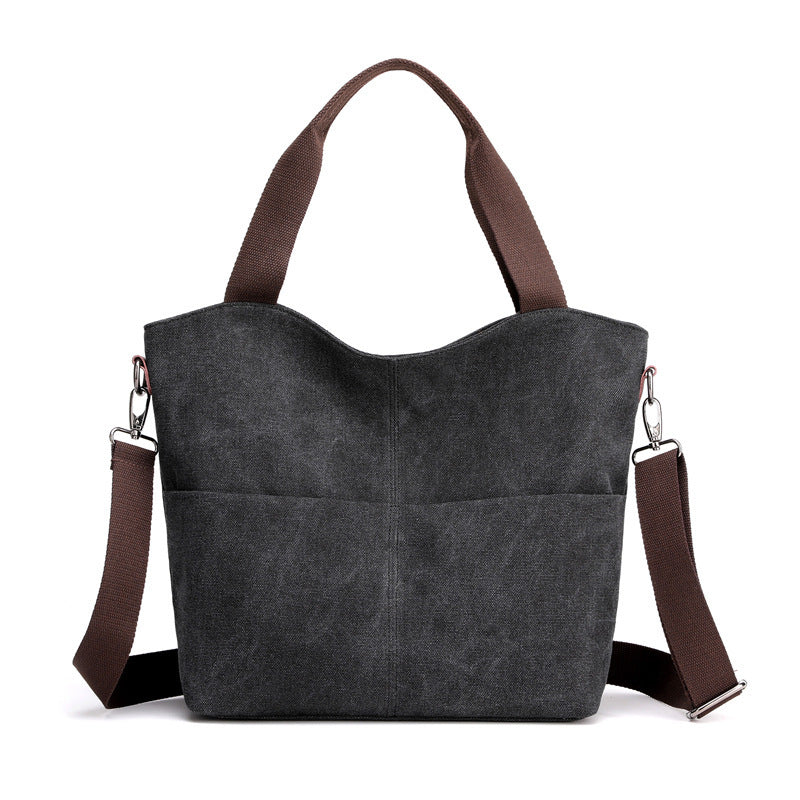 Black canvas tote handbag in a white canvas