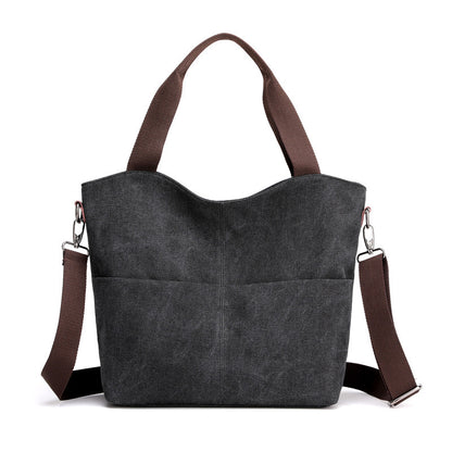 Black canvas tote handbag in a white canvas