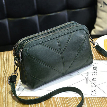 Green army Chic EcoAura Vegan Leather Shoulder Bag positioned on a table