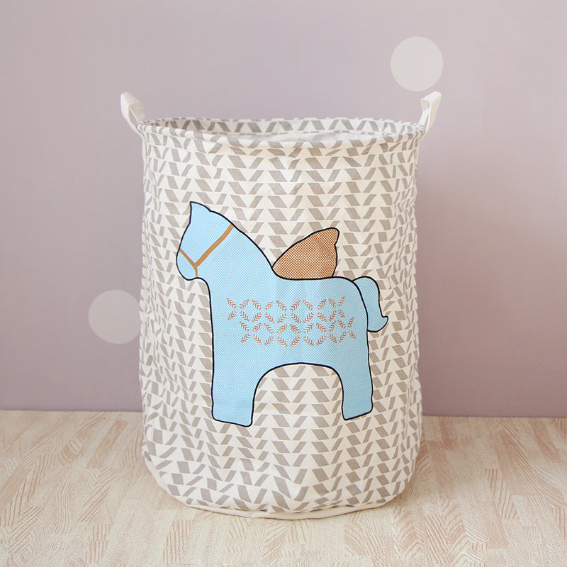 A cotton and linen storage basket with a blue horse design in a play room