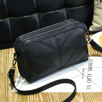 Black Chic EcoAura Vegan Leather Shoulder Bag positioned on a table