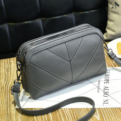 Grey Chic EcoAura Vegan Leather Shoulder Bag positioned on a table