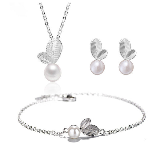 An elegant set of leaf pearl jewelry set on a white canvas