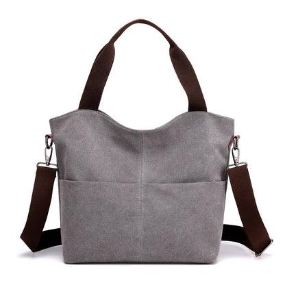 Grey canvas tote handbag in a white canvas