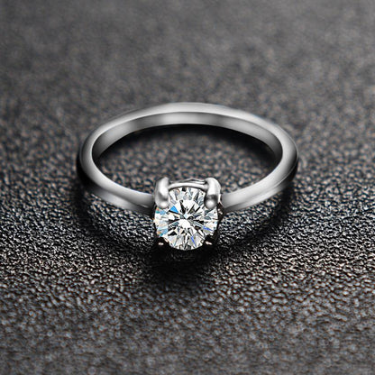 Luxury zircon wedding ring on a granulated grey surface