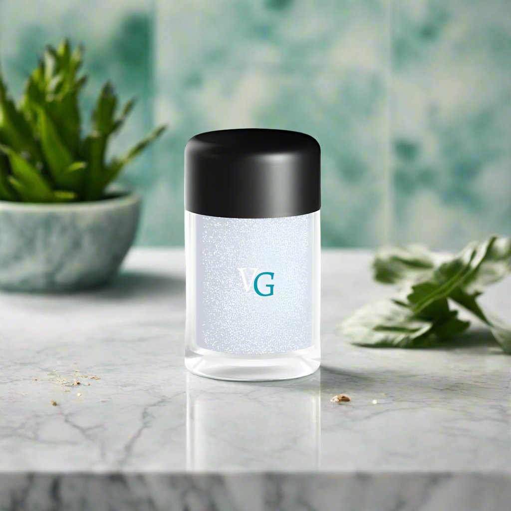 An elegant container of dust glitter on a marble surface and plants