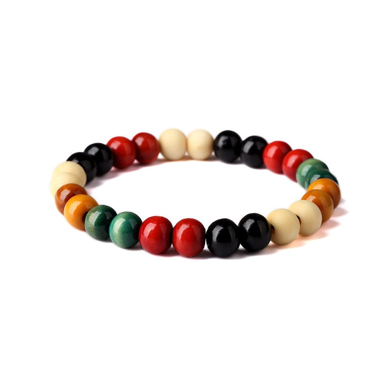  a multicolored wooden bracelet in a white canvas