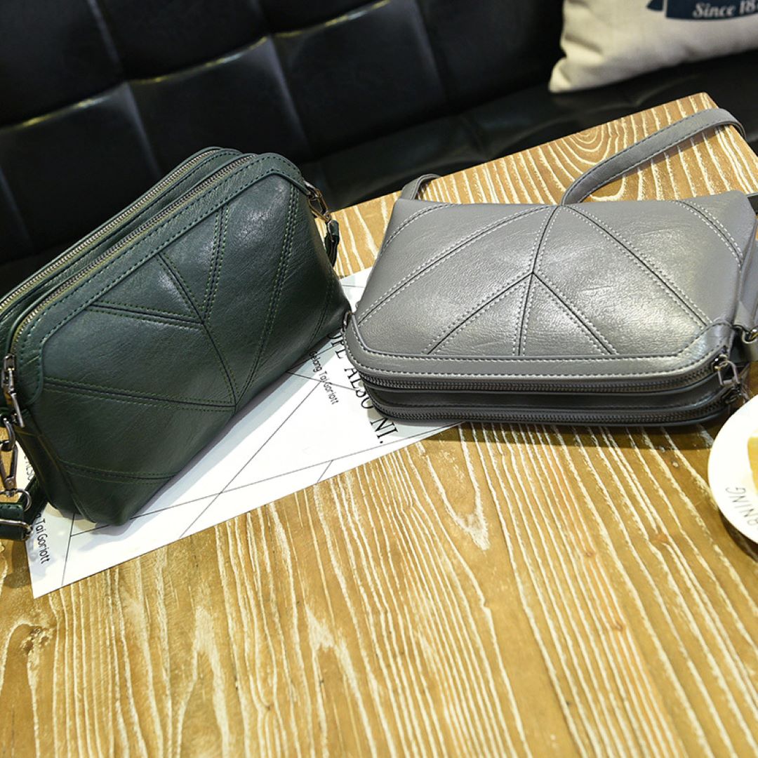 Deux Chic Eco Aura Vegan Leather Shoulder Bag positioned on a table