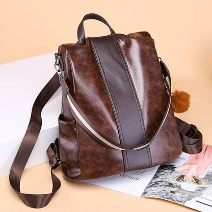 Brown faux leather backpack over a magazine