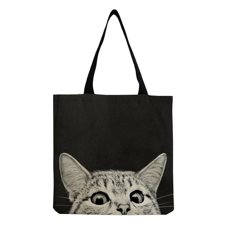 black tote bag with a grey cat showing from the bottom