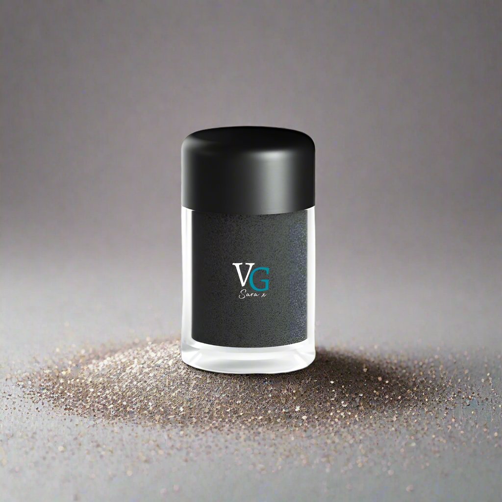 container of deep black dust glitter on a grey dusty canvas