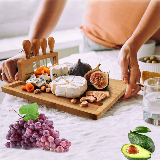 Woman presenting a bamboo cheese board featuring grapes, avocado slices, and cheese