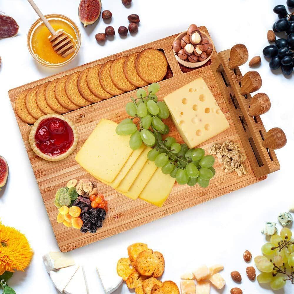 Artfully arranged bamboo cheese board with grapes, assorted nuts, and a variety of cheeses