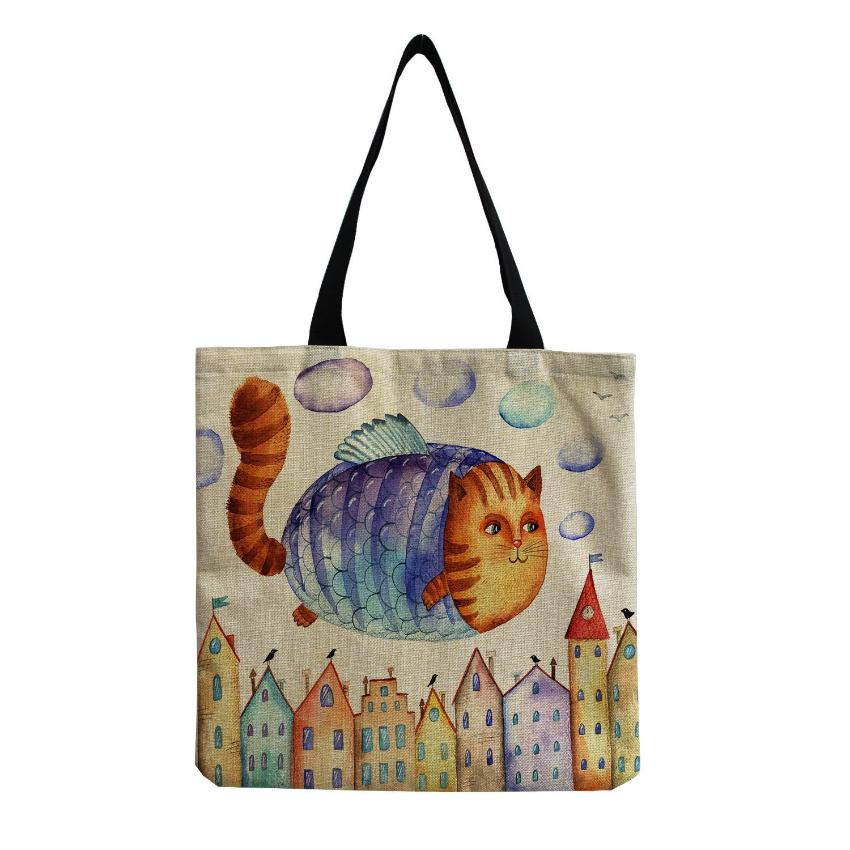 a fish cat flying over colored houses printed in a tote bag