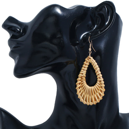 handmade rattan drop earrings on an ear