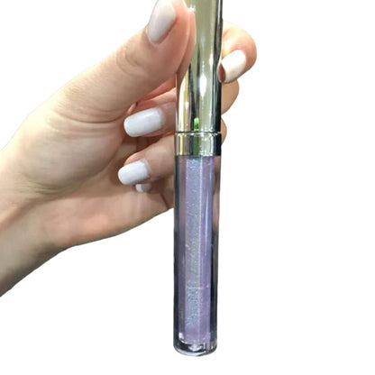 A woman's hand holding a Galactic Lip Gloss from Cosmic Glow collection 