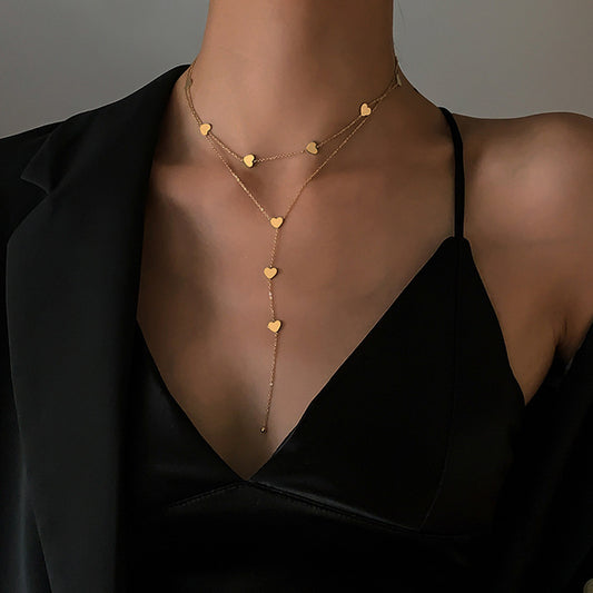 woman wearing an eco-friendly golden hearts long necklace