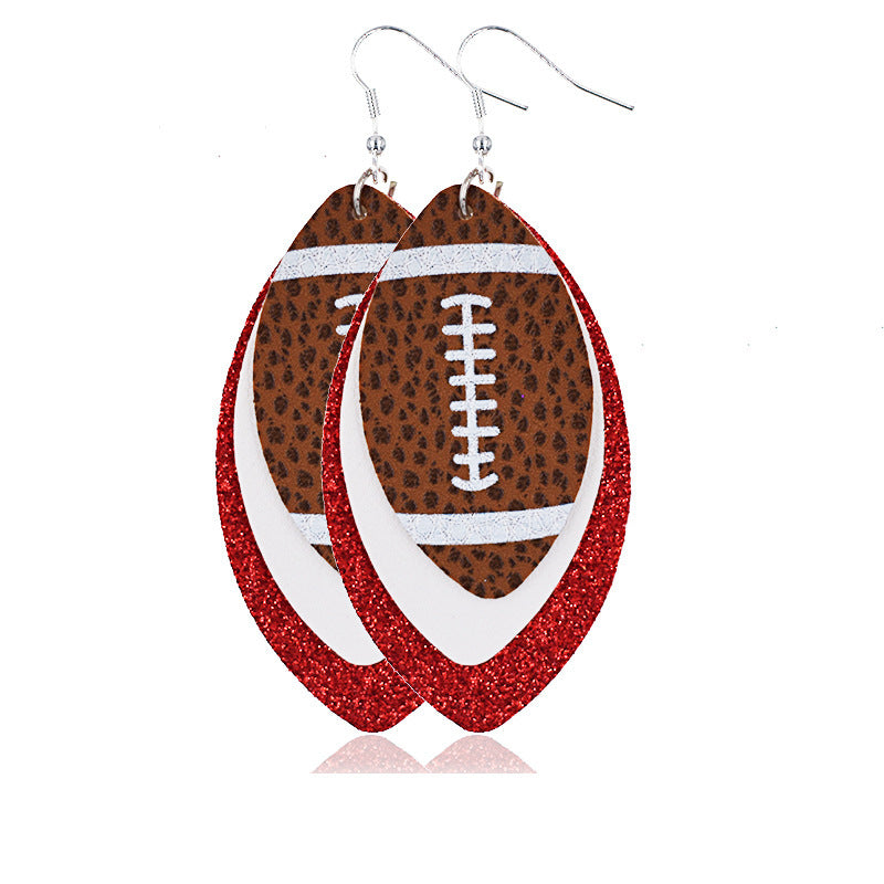 a pair of earrings in red and a ball of rugby