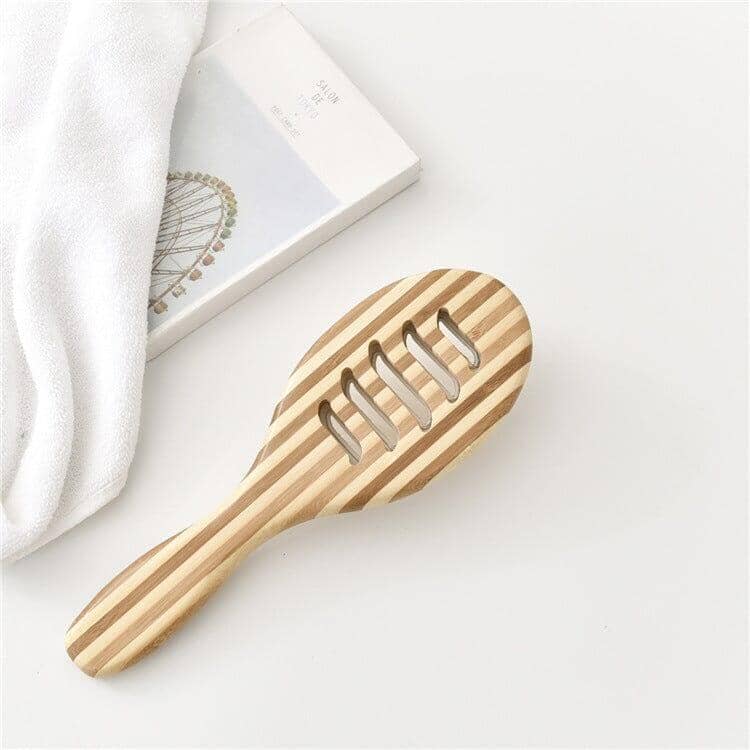 Bamboo massage comb accompanied by a towel
