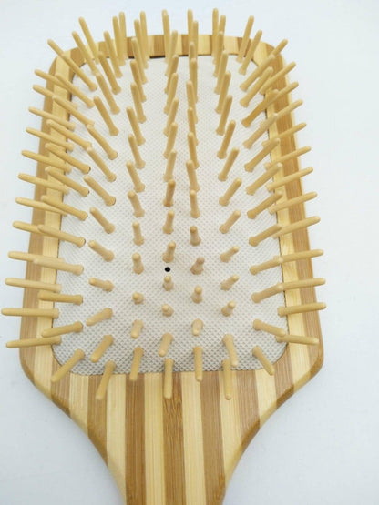 Bamboo hairbrush featuring dense wooden pins for scalp stimulation