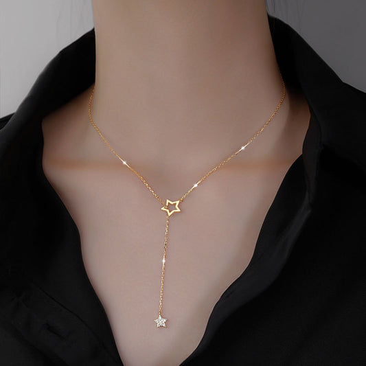 woman wearing a gold-diamond-star tassel necklace